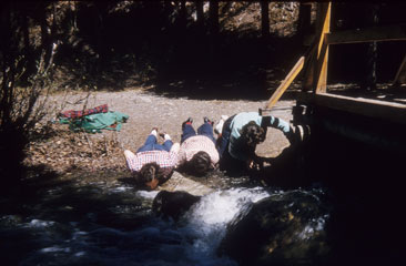 Women drinking water from creek